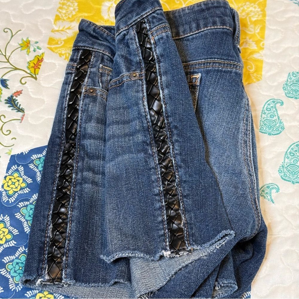 American Eagle shorts with raw hem and faux leather braided detailing
